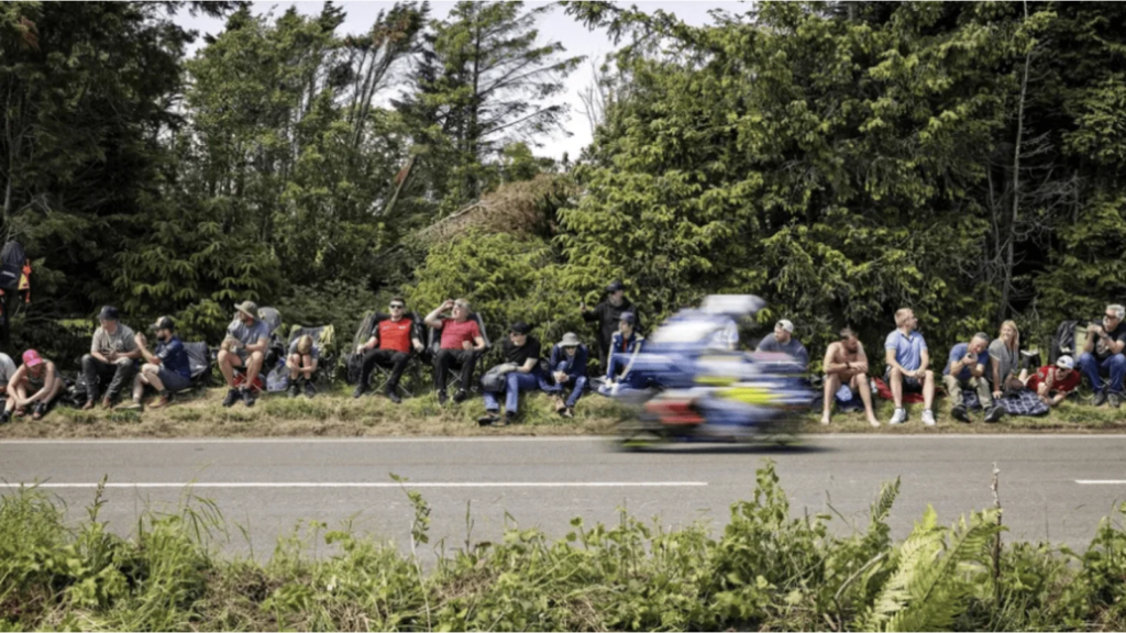 A rider flying past fans at the Isle of Man TT. Credit: Isle of Man TT.