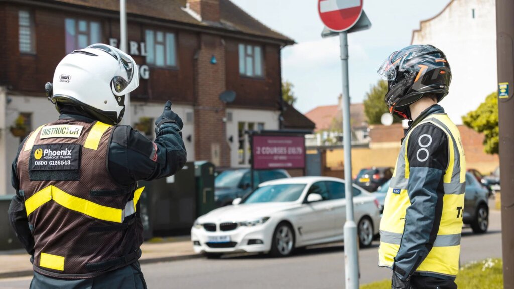 Motorcycle instructor teaching a learner rider