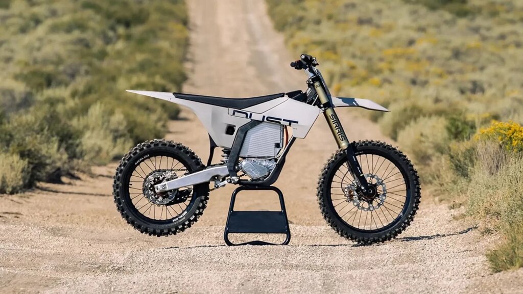 A Dust Moto electric dirt bike on a dusty track